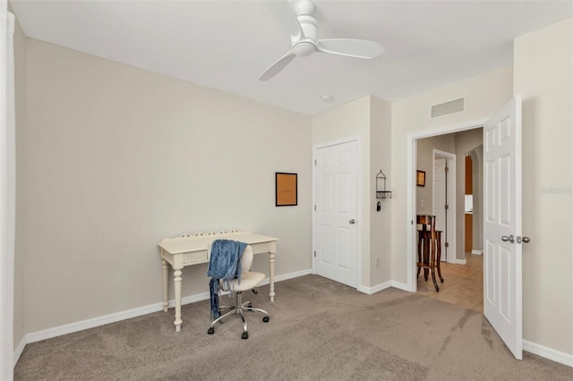 office space featuring ceiling fan and light carpet