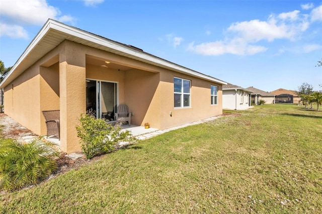 rear view of property featuring a lawn