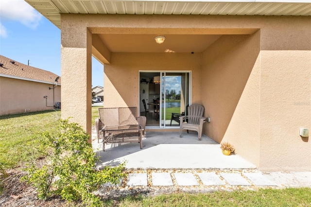 view of exterior entry with a patio area