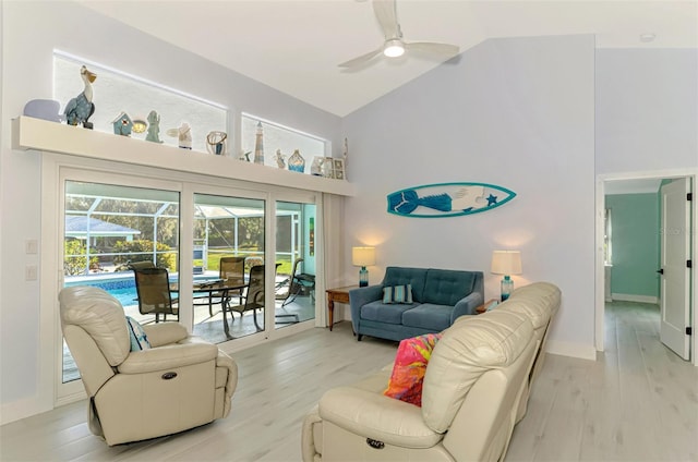 living room featuring high vaulted ceiling, ceiling fan, and light wood-type flooring