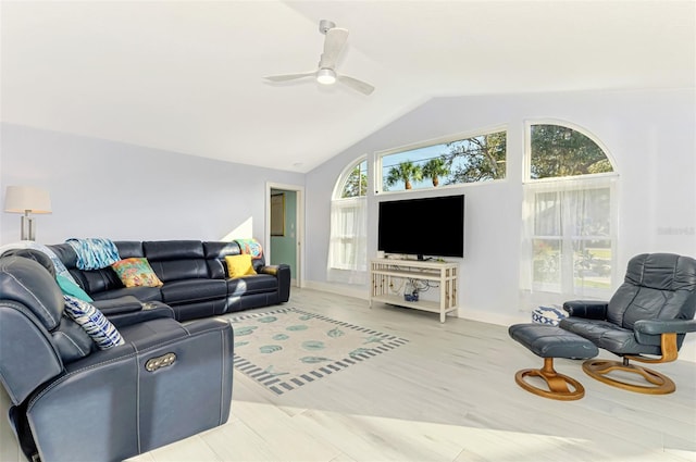 living room with lofted ceiling, plenty of natural light, a ceiling fan, and wood finished floors