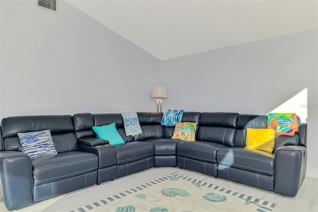 living area featuring lofted ceiling and visible vents