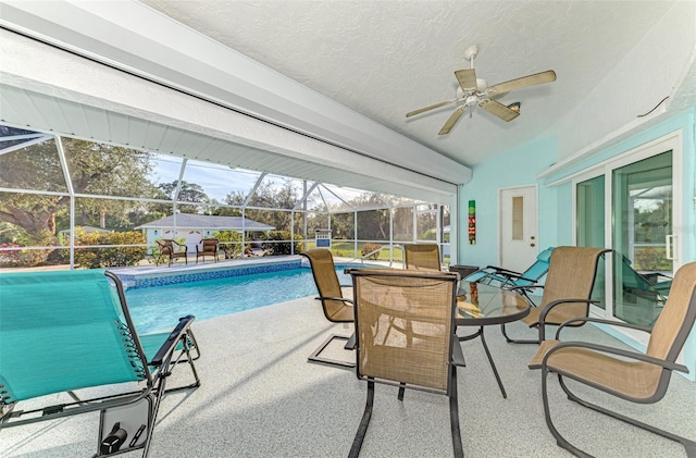 view of swimming pool featuring a patio area and glass enclosure