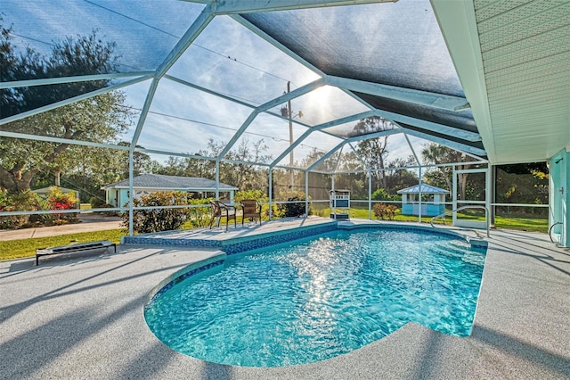 outdoor pool featuring glass enclosure and a patio area