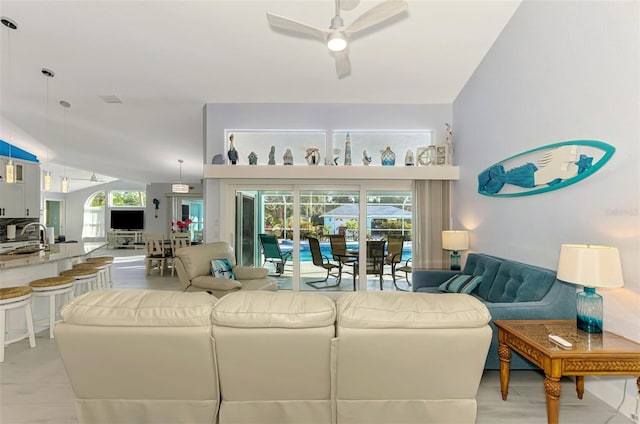 living room featuring a healthy amount of sunlight, sink, and ceiling fan