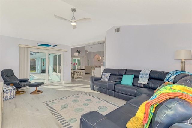 living room featuring lofted ceiling and ceiling fan