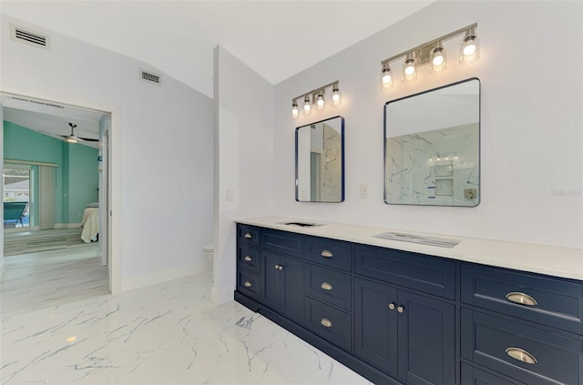 bathroom with lofted ceiling, vanity, and toilet