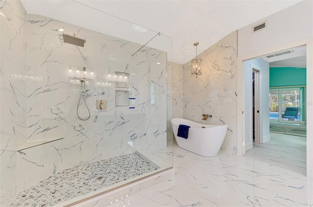 full bathroom with a marble finish shower, visible vents, a soaking tub, marble finish floor, and stone wall