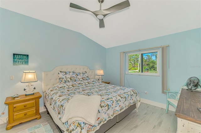 bedroom with vaulted ceiling, ceiling fan, and light wood-type flooring