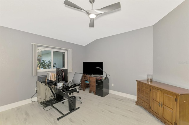 home office with a ceiling fan, lofted ceiling, light wood finished floors, and baseboards