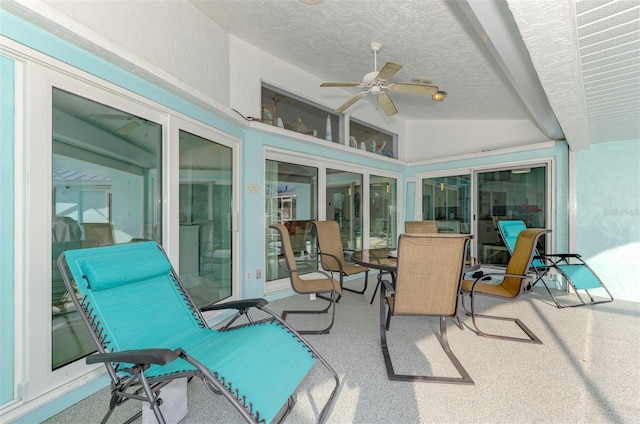 sunroom featuring vaulted ceiling and ceiling fan