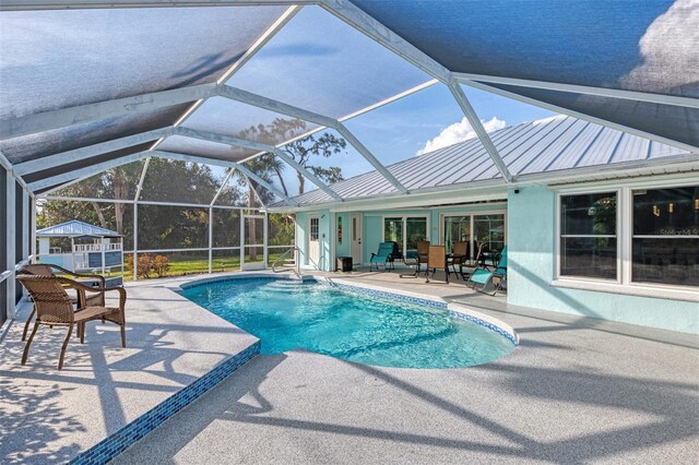 view of pool featuring a patio area and glass enclosure