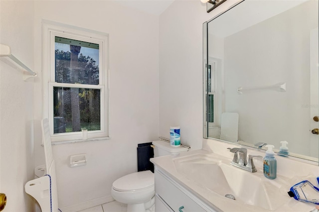 bathroom featuring vanity, toilet, and tile patterned flooring