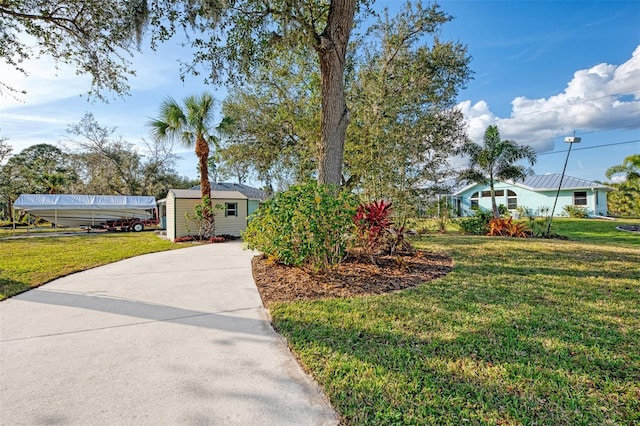 view of front of property with a front lawn and a storage unit