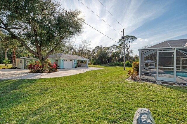 view of yard featuring a garage, a lanai, and a storage shed