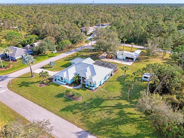 birds eye view of property with a view of trees