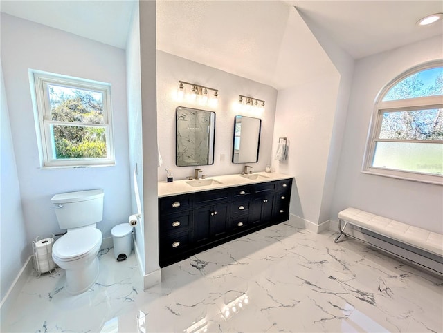 full bath with marble finish floor, a sink, and baseboards