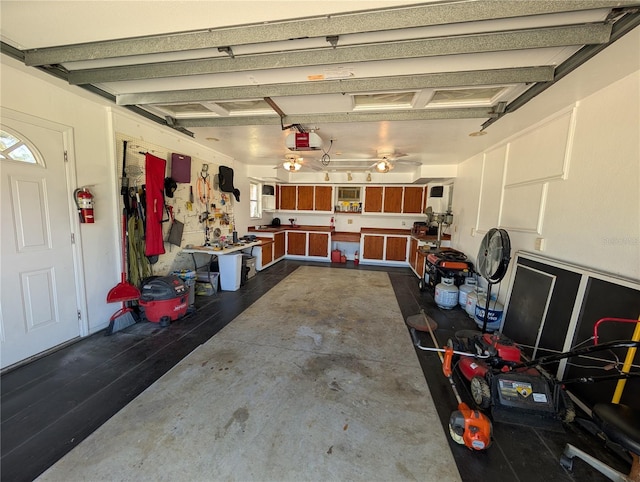 garage with a garage door opener and a workshop area