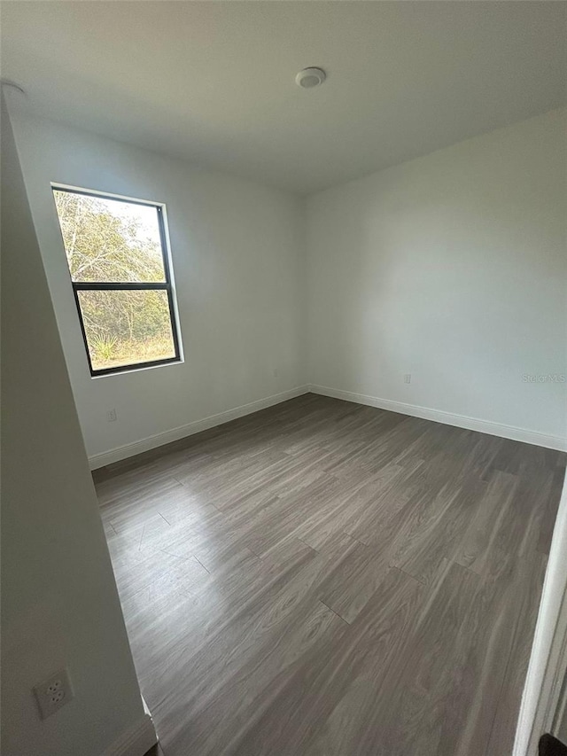 empty room featuring dark wood-type flooring