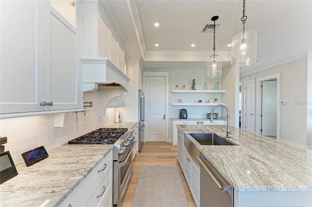 kitchen with a kitchen island with sink, high quality appliances, light stone countertops, white cabinets, and decorative light fixtures