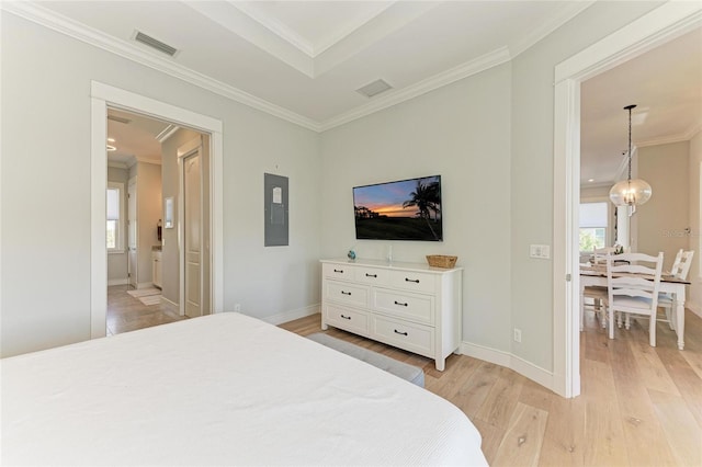 bedroom featuring multiple windows, crown molding, and light hardwood / wood-style floors