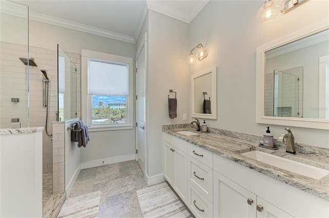 bathroom with ornamental molding, vanity, and a tile shower