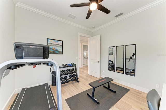 workout area featuring hardwood / wood-style flooring, ornamental molding, and ceiling fan