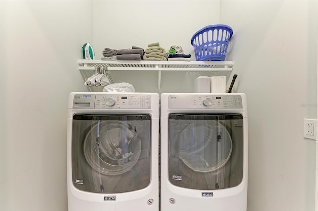 clothes washing area featuring washer and clothes dryer