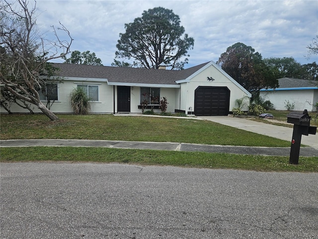 ranch-style house with a garage and a front lawn