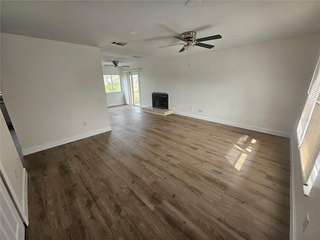 unfurnished living room featuring ceiling fan and hardwood / wood-style floors