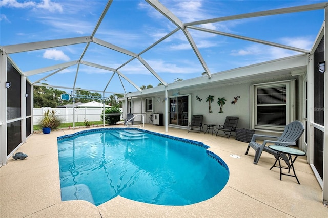 view of pool with a lanai and a patio