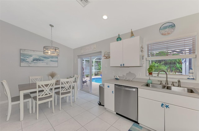 kitchen featuring lofted ceiling, sink, hanging light fixtures, stainless steel dishwasher, and white cabinets