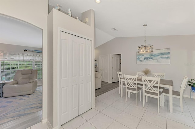 tiled dining area featuring lofted ceiling