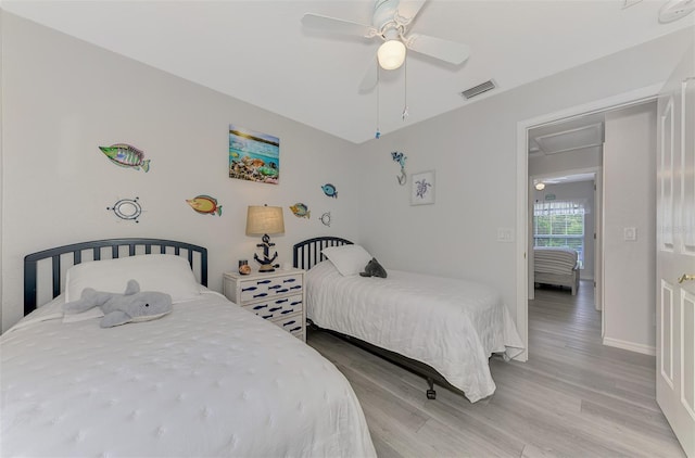 bedroom with ceiling fan and light wood-type flooring