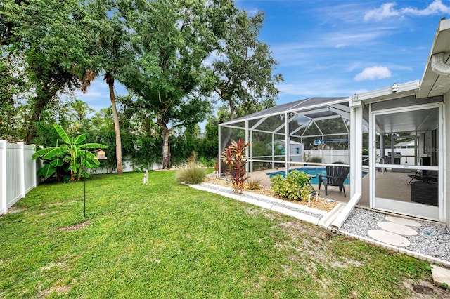 view of yard featuring a fenced in pool, a patio area, and glass enclosure