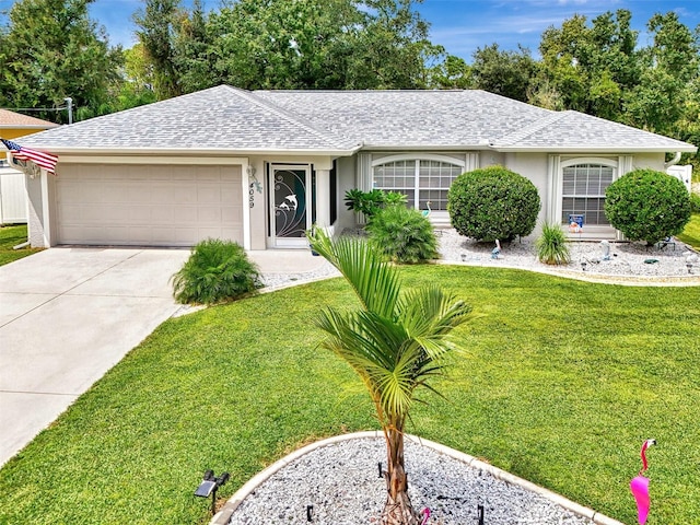 ranch-style home featuring a garage and a front yard