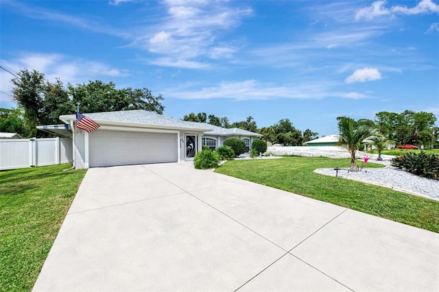 single story home featuring a garage and a front lawn