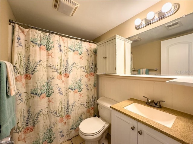 bathroom with vanity, walk in shower, and toilet