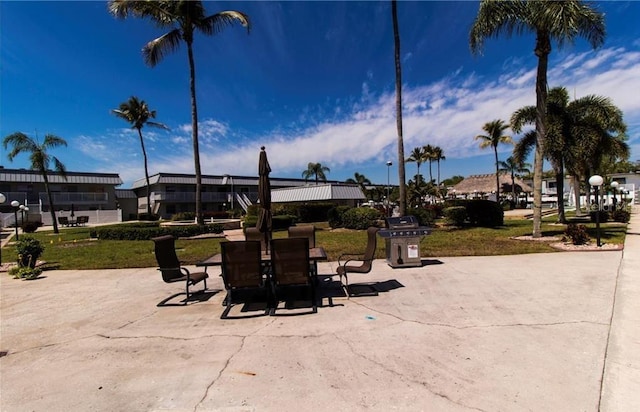 view of community with a lawn and a patio