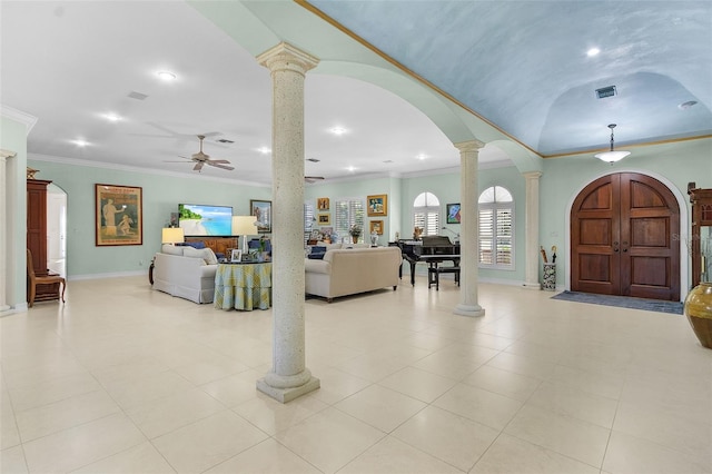 entryway featuring ornate columns, crown molding, and ceiling fan