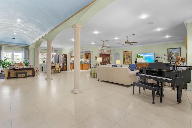 living room with crown molding, decorative columns, and ceiling fan