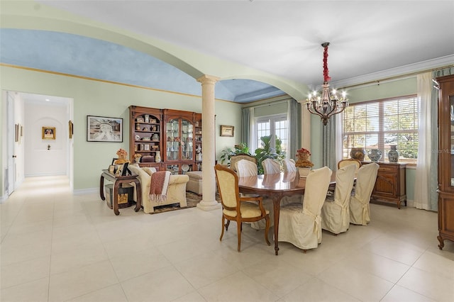 dining area with a notable chandelier, ornamental molding, and ornate columns