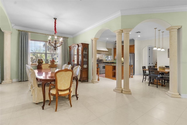 dining room with ornate columns, ornamental molding, and a chandelier