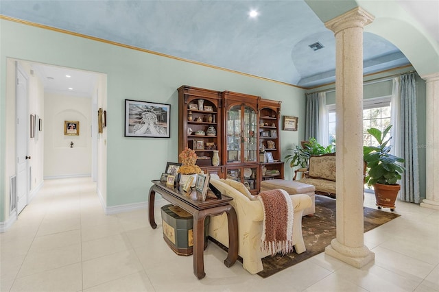 sitting room featuring light tile patterned floors, crown molding, vaulted ceiling, and ornate columns