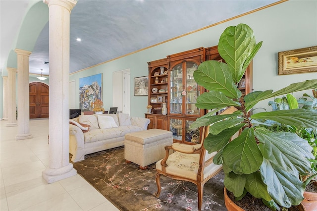 living area with ornate columns, crown molding, and tile patterned flooring