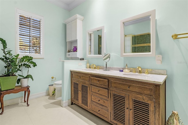 bathroom featuring tile patterned flooring, vanity, ornamental molding, and toilet