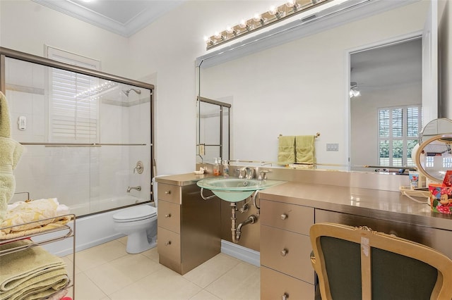 full bathroom featuring sink, combined bath / shower with glass door, tile patterned flooring, ornamental molding, and toilet