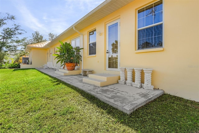 rear view of house featuring a patio and a lawn