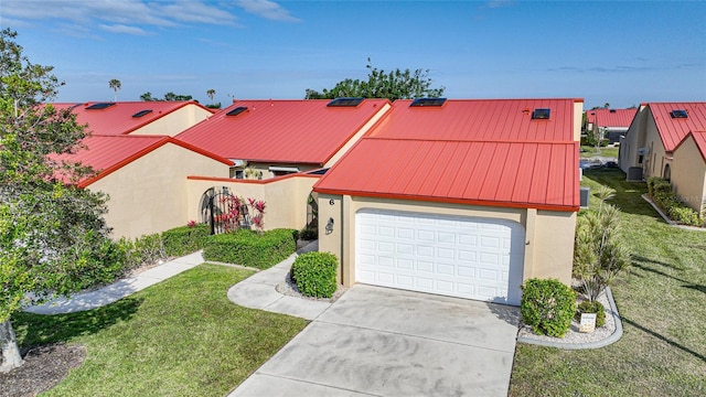 view of front of property with a garage, cooling unit, and a front lawn