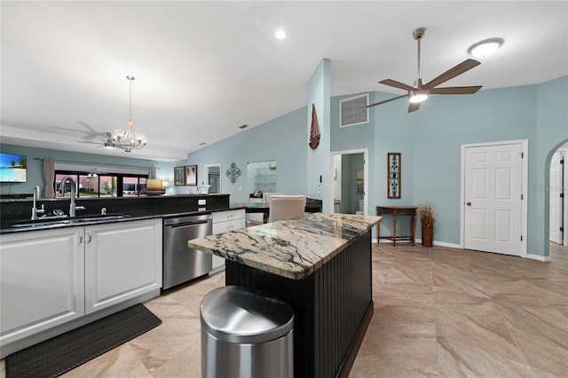 kitchen featuring ceiling fan with notable chandelier, sink, white cabinets, a center island, and stainless steel dishwasher